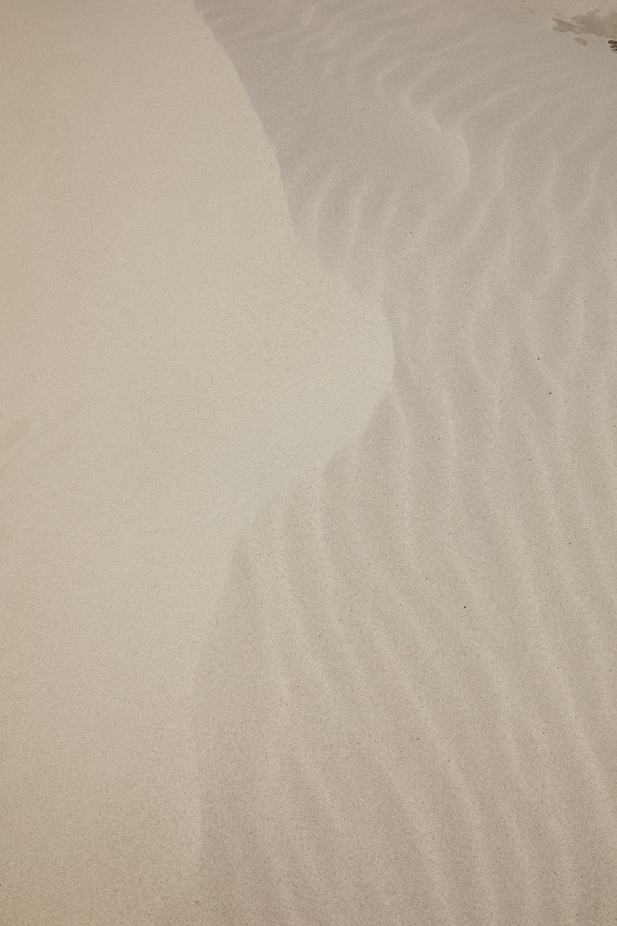 white sandy surface on sea shore
