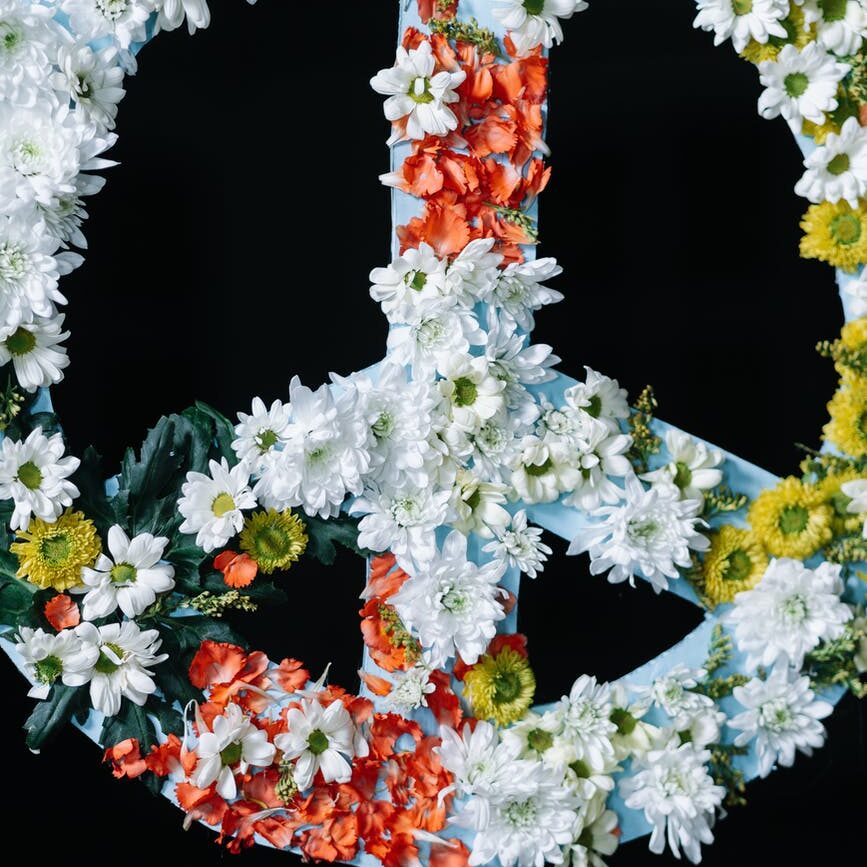 peace sign banner covered in flowers