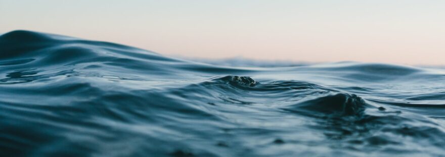 body of water under blue and white skies