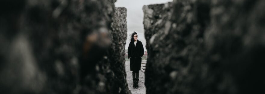 woman standing between rocks