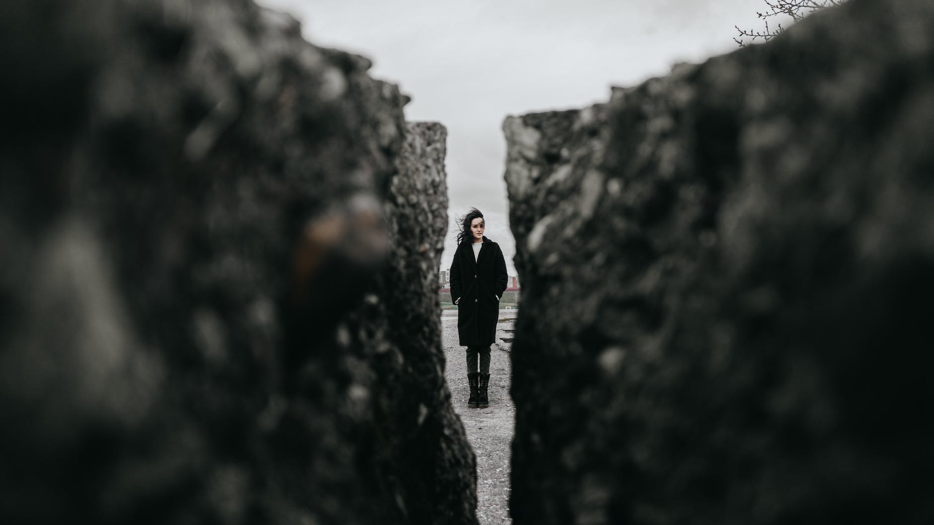 woman standing between rocks